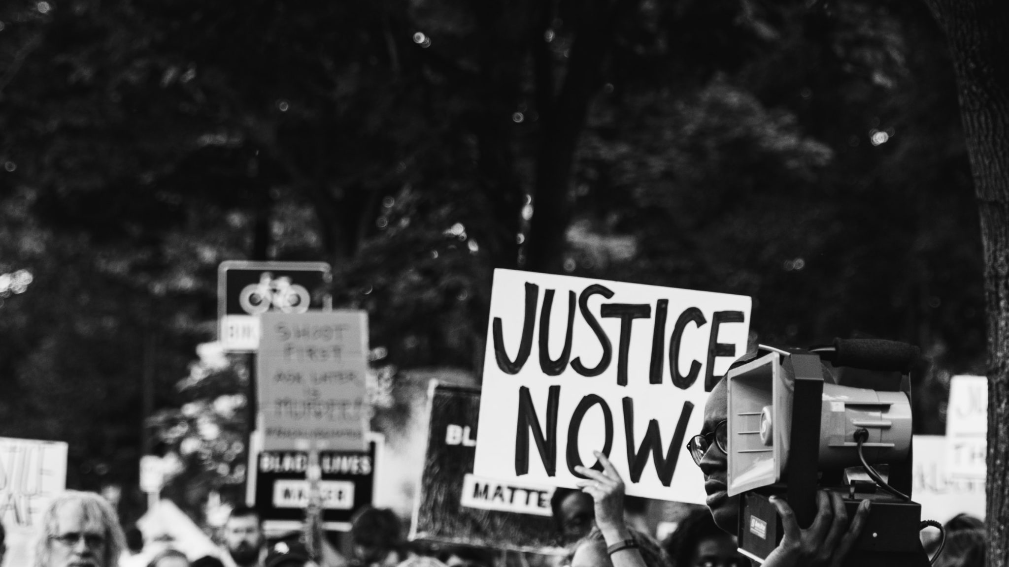 a sign that says justice at a street protest