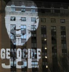 Projection of Joe's face on the white house that says Genocide Joe